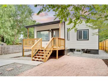 Charming home with a newly built wooden deck and fresh gravel landscaping at 261 Knox Ct, Denver, CO 80219