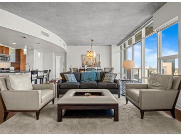Bright, modern living room with floor-to-ceiling windows and sophisticated decor and city view at 891 14Th St # 3510, Denver, CO 80202