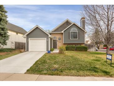 Charming home featuring a garage, brick accents, and well-maintained front yard at 18206 E Tanforan Pl, Aurora, CO 80015