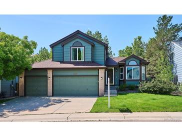 Charming two-story home with a three-car garage and mature landscaping at 5651 S Himalaya Way, Centennial, CO 80015