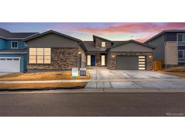 New construction home with stone accents and two-car garage at 14408 Hop Clover Trl, Parker, CO 80134