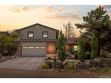 Charming home featuring a two-car garage, brick accents, and well-manicured landscaping at 14533 W 3Rd Ave, Golden, CO 80401