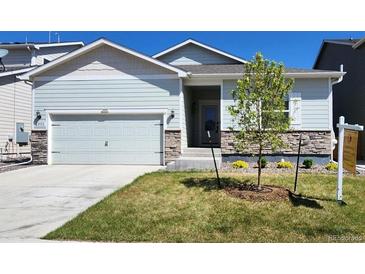 Charming single-Gathering home with light blue siding, a two-car garage, and a well-maintained lawn at 2303 Angus St, Mead, CO 80542