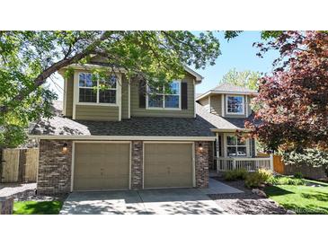 Charming two-story home features a well-manicured lawn, brick accents and attached two-car garage at 2980 E 135Th Dr, Thornton, CO 80241