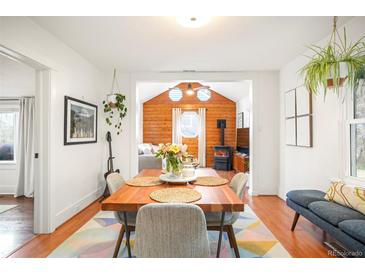 Inviting dining room featuring natural light, wood floors, table for four, and stylish decor at 1232 Wabash St, Denver, CO 80220