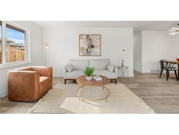 Bright living room features modern decor, neutral color palette, stylish furnishings, and plenty of natural light at 3313 Jasmine St, Denver, CO 80207