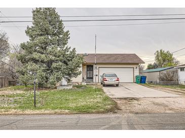 Charming home featuring a mature tree, inviting curb appeal, and an attached two-car garage at 6132 S Grant St, Centennial, CO 80121