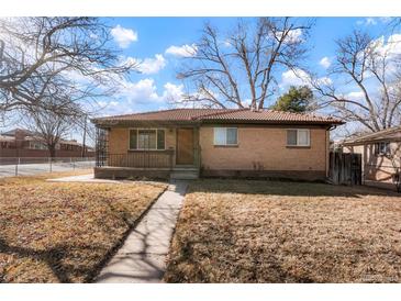 Charming brick home featuring a cozy front porch and mature trees in the front yard at 2695 S Josephine St, Denver, CO 80210