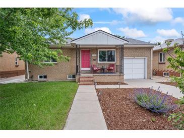 Charming brick home featuring a well-maintained front yard, walkway, and a delightful covered front porch and a one car garage at 3241 Sheridan Blvd, Wheat Ridge, CO 80212