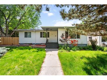 Charming single-story home with a well-manicured lawn and inviting walkway at 3131 S Washington St, Englewood, CO 80113