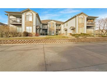 Attractive exterior of a two-story townhome with stone accents and balconies at 10381 Cook Way # 205, Thornton, CO 80229