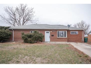 Charming brick home with a well-maintained front yard and mature landscaping, offering great curb appeal at 840 Tucson St, Aurora, CO 80011