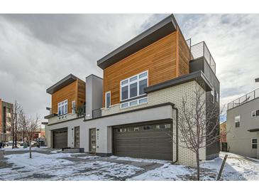 Two modern townhomes with wood siding and attached garages at 2804 W 53Rd Ave, Denver, CO 80221