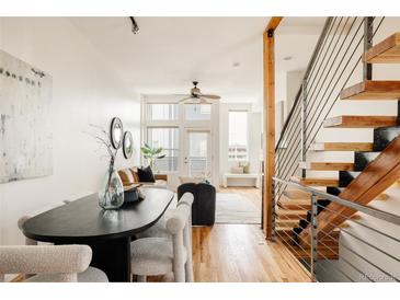 Bright living space featuring an open floor plan, hardwood floors and a staircase at 2680 Blake St # 12, Denver, CO 80205
