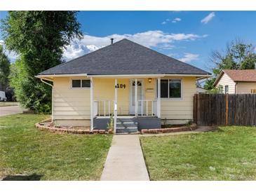 Charming single Gathering home featuring a yellow exterior and landscaped front yard at 109 6Th St, Fort Lupton, CO 80621