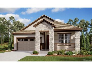 Charming single-story home featuring stone accents, a covered porch, and a manicured front lawn at 39161 Anthony St, Elizabeth, CO 80107