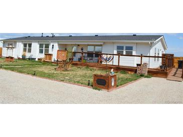 Charming single-story home with a wooden deck and gravel landscaping at 11299 E 159Th Pl, Brighton, CO 80602