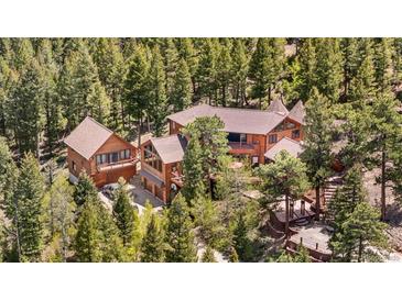 Stunning mountain home nestled among trees with multi-level decks and a separate guest house at 4618 Se Summit Trl, Evergreen, CO 80439