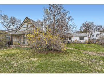 Charming home exterior featuring a lawn, mature landscaping, and inviting curb appeal at 1824 S Logan St, Denver, CO 80210