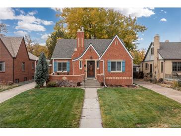 Brick home with landscaped lawn and walkway at 1545 Newport St, Denver, CO 80220