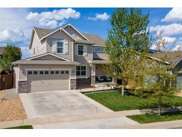 Charming two-story home featuring a manicured lawn and attached two-car garage at 15389 W 50Th Dr, Golden, CO 80403