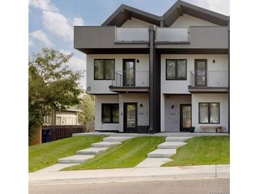 Modern townhome featuring a contemporary design, private balconies, and a well-manicured front lawn at 1660 Utica St, Denver, CO 80204