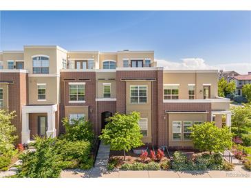 Inviting multi-level townhome with manicured front yard landscaping at 9158 Martin Luther King Blvd, Denver, CO 80238