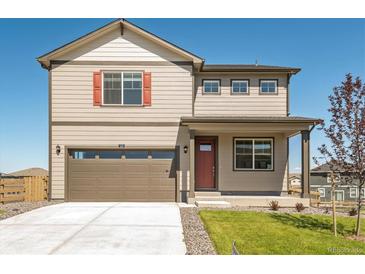 Charming two-story home features a two-car garage, tidy landscaping, and inviting front porch at 27460 E Cedar Pl, Aurora, CO 80018