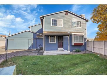 Charming two-story home with a well-maintained lawn and welcoming front porch at 10008 Quivas St, Thornton, CO 80260