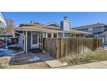 Ranch style home with wood fence and parking at 261 S Newark Cir, Aurora, CO 80012