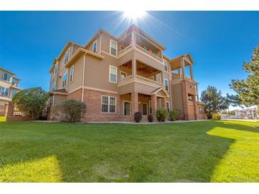 Attractive multi-story condo building with brick accents, multiple balconies, and well-maintained landscaping at 12760 Ironstone Way # 103, Parker, CO 80134