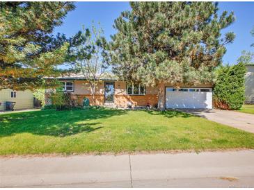 Charming single-story home with brick accents, mature trees, and a well-maintained lawn at 13133 Regulus Dr, Lone Tree, CO 80124