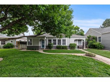 Charming home with a well-maintained front yard, mature tree, and inviting walkway at 2640 S Marion St # 2646, Denver, CO 80210