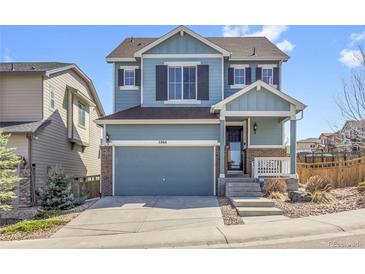 Charming two-story home featuring a blue exterior, a spacious two-car garage, and well-maintained landscaping at 3266 Riverwood Way, Castle Rock, CO 80109