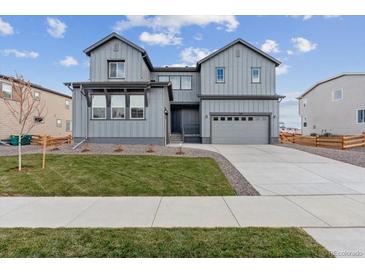 Two-story house with gray siding, landscaped lawn, and a two-car garage at 1750 Marlowe W Cir, Erie, CO 80516