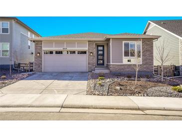 Charming single-story home with stone accents, a two-car garage, and modern curb appeal at 8829 Animas River St, Littleton, CO 80125