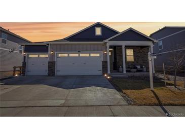 Charming two-story home with a two car garage and a beautifully landscaped front yard at 7414 E 158Th Pl, Thornton, CO 80602