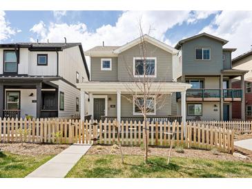 Charming two-story home with a picket fence and covered porch, perfect for relaxing and enjoying the neighborhood at 320 Marshall Mews, Superior, CO 80027