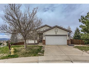 Charming single Gathering home featuring a driveway, two-car garage and mature landscaping at 815 Concho Ct, Castle Rock, CO 80104