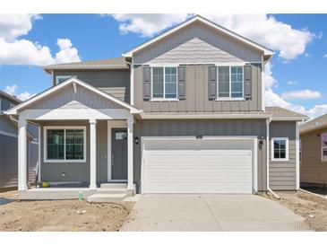 Charming two-story home featuring a two-car garage and a covered front porch at 842 N Deer Park St, Watkins, CO 80137