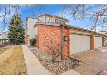 Charming townhouse with a brick facade, two-car garage, and well-kept landscaping at 7900 W Layton Ave # 864, Littleton, CO 80123