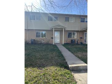 Two-story townhouse featuring a brick facade with a covered front porch at 4505 Everett St, Wheat Ridge, CO 80033