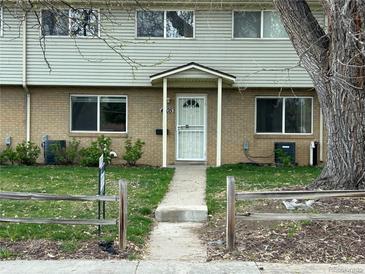 Charming townhome featuring a secure white screen door and a covered entrance, enhancing curb appeal at 4505 Everett St, Wheat Ridge, CO 80033