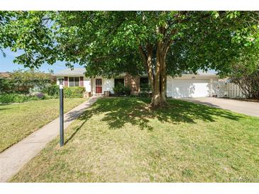 Charming single-story home with mature tree, lush lawn, and attached two car garage at 291 Magnolia St, Denver, CO 80220