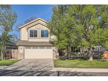 Charming two-story home with a two-car garage, front yard, and mature trees at 10963 Bryant St, Westminster, CO 80234