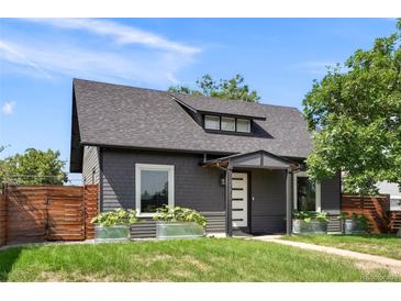 Charming home featuring a well-manicured lawn, gray siding and stylish planters enhancing the curb appeal at 2253 S Fox St, Denver, CO 80223