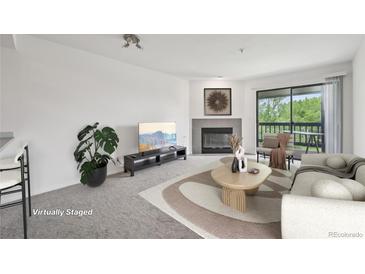 Bright living room features a fireplace, modern decor, and sliding doors to a balcony at 2727 Folsom St # 303, Boulder, CO 80304