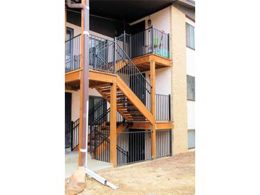 Apartment building featuring updated wooden staircases and wrought iron railings at 875 S Quebec St # 25, Denver, CO 80247