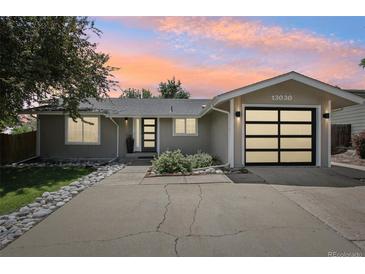 Charming single-story home with a modern garage door and drought resistant rock landscaping at 13030 King Cir, Broomfield, CO 80020