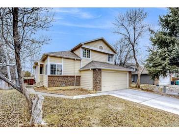 Charming two-story home with brick accents, attached garage, and well-maintained front yard in a quiet neighborhood at 3653 S Flanders St, Aurora, CO 80013